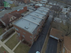 Drone footage of series of roofs on an apartment complex - Total Roofing and Construction
