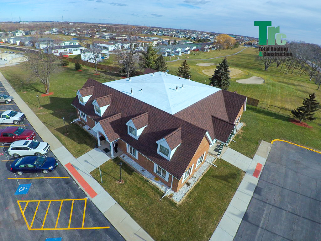 an aerial view of a building with a Total Roofing & Constructionlogo