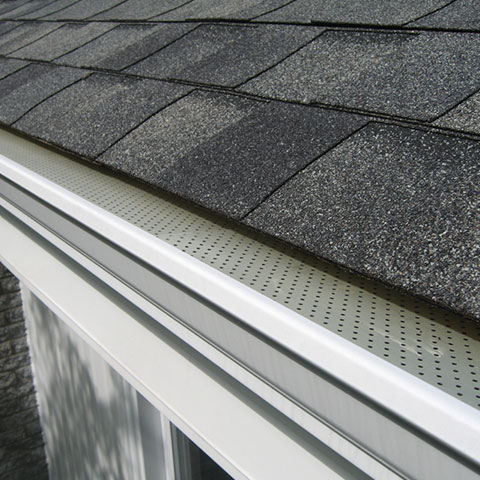 a close up of a gutter on a roof of a house .